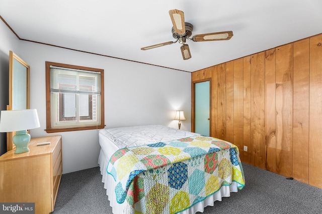 411 146th St Unit 325, Ocean City, MD 21842 - bedroom featuring dark colored carpet, wood walls, and a ceiling fan