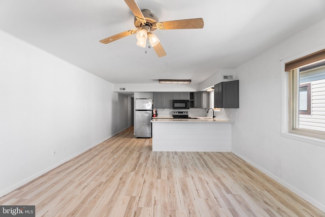 411 146th St Unit 325, Ocean City, MD 21842 - kitchen featuring stainless steel appliances, light countertops, a peninsula, light wood finished floors, and gray cabinetry