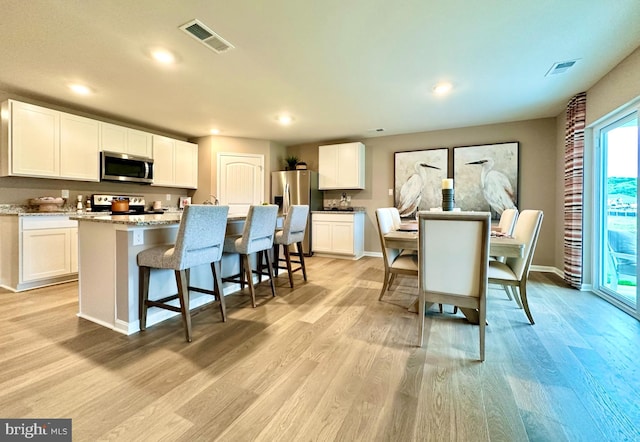 dining space featuring light hardwood / wood-style floors