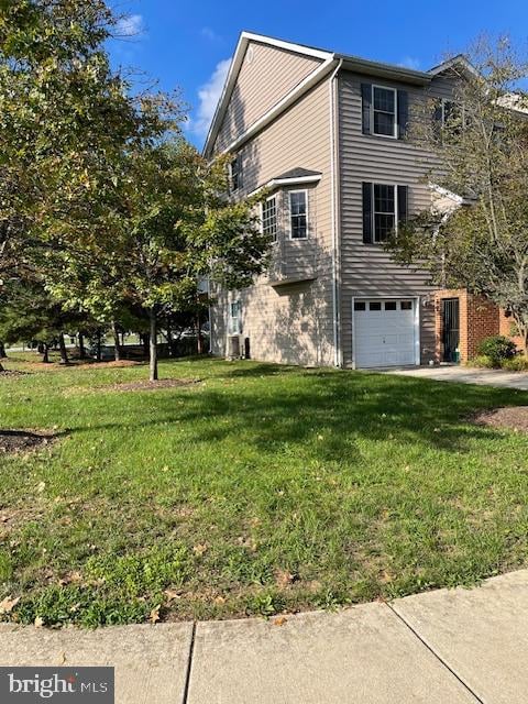 view of front of home with a garage and a front yard