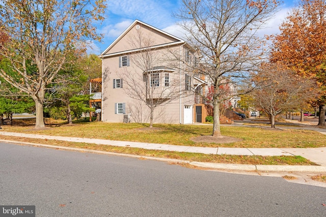 view of side of home with a lawn