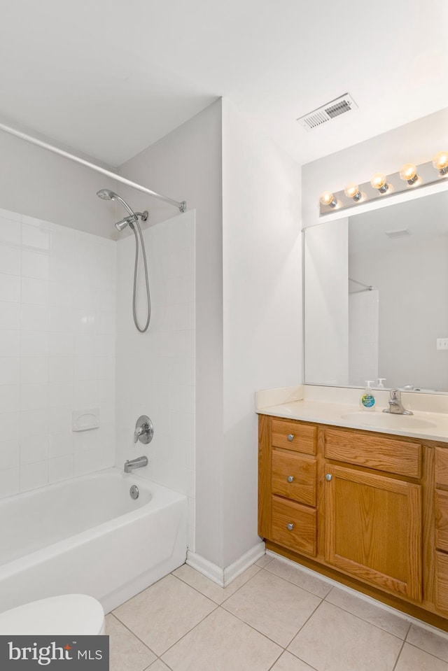 full bathroom with vanity, tile patterned flooring, toilet, and tiled shower / bath combo