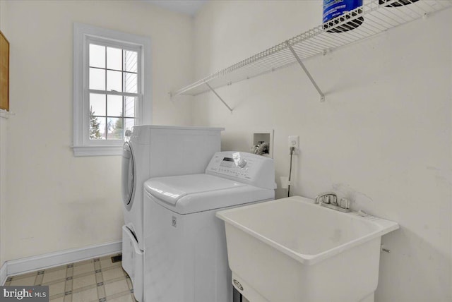 laundry room with sink and washer and clothes dryer