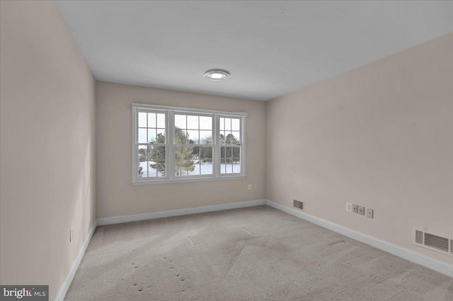 carpeted empty room featuring a water view