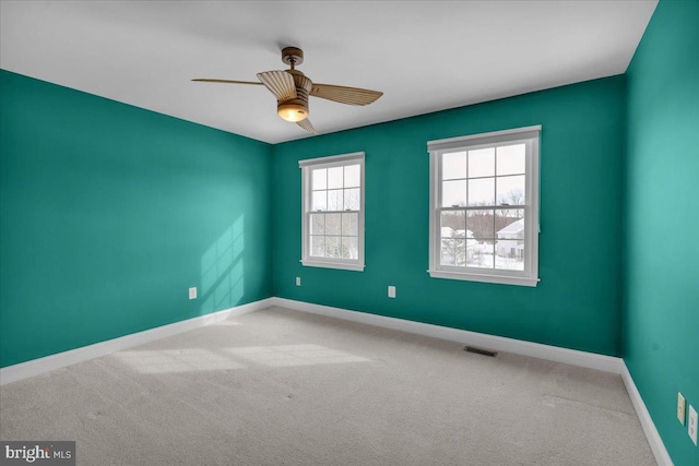 spare room featuring ceiling fan and carpet flooring