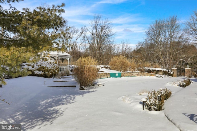 yard layered in snow featuring a gazebo