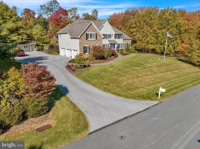 view of front of property featuring a garage and a front yard