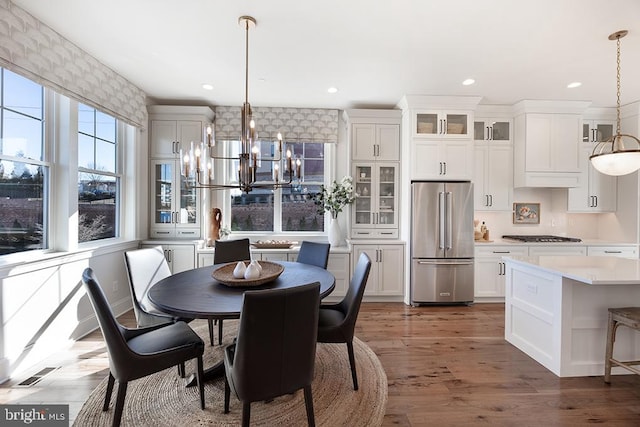 dining area featuring dark wood-type flooring and a chandelier