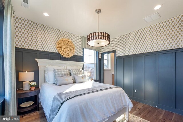 bedroom with dark hardwood / wood-style flooring