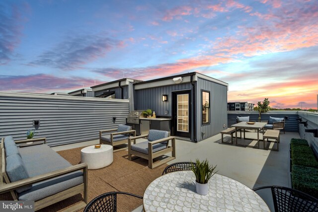 patio terrace at dusk with an outdoor living space