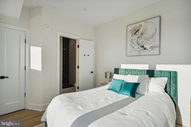 bedroom with a closet and hardwood / wood-style floors