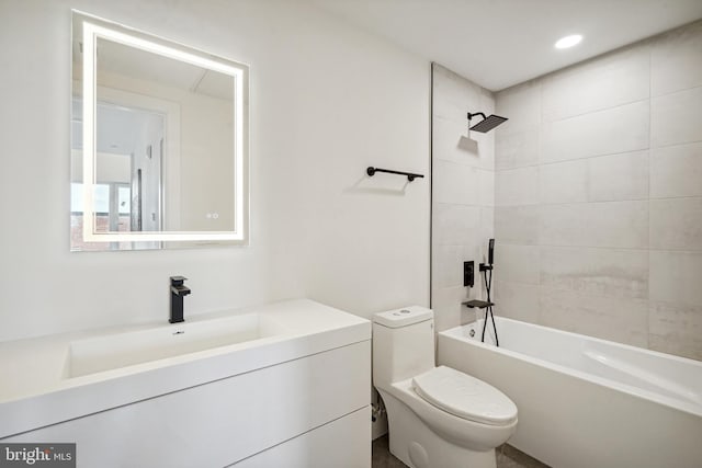 full bathroom featuring tiled shower / bath combo, vanity, and toilet