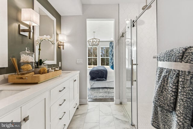 bathroom featuring vanity and a shower with shower door