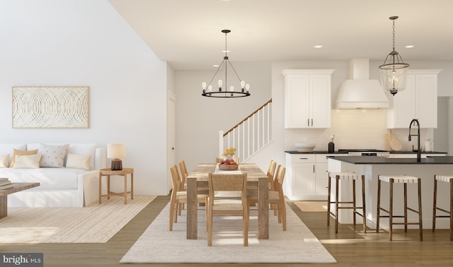 dining area with a notable chandelier, dark hardwood / wood-style floors, and sink