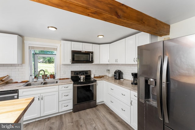 kitchen with white cabinets, sink, and appliances with stainless steel finishes