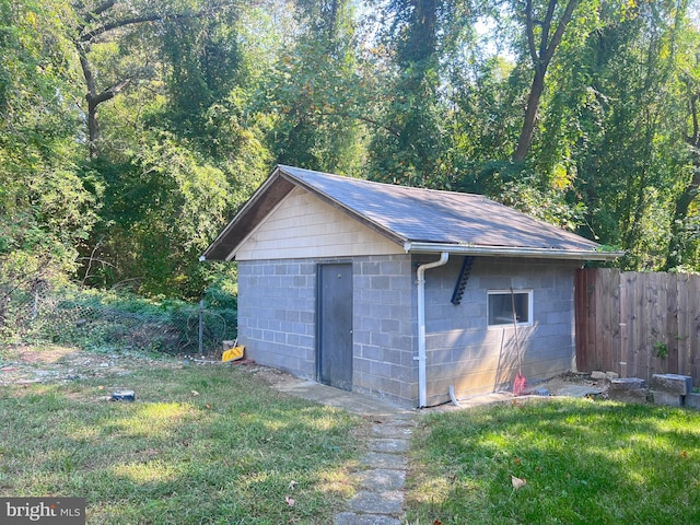 view of outdoor structure featuring a lawn