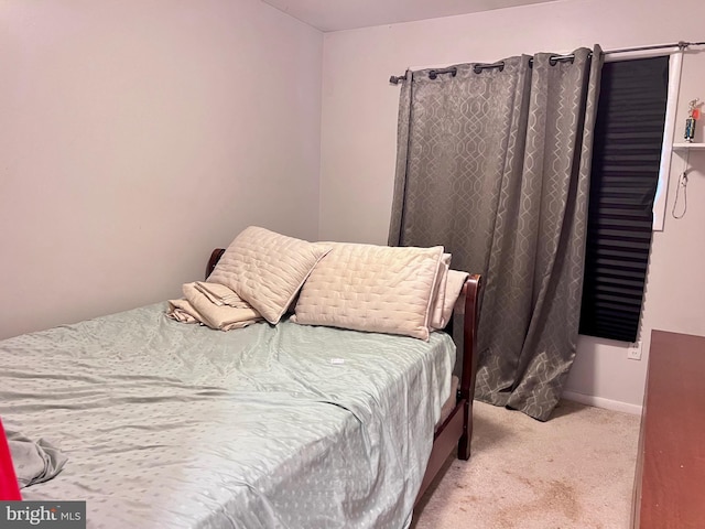 bedroom featuring light carpet