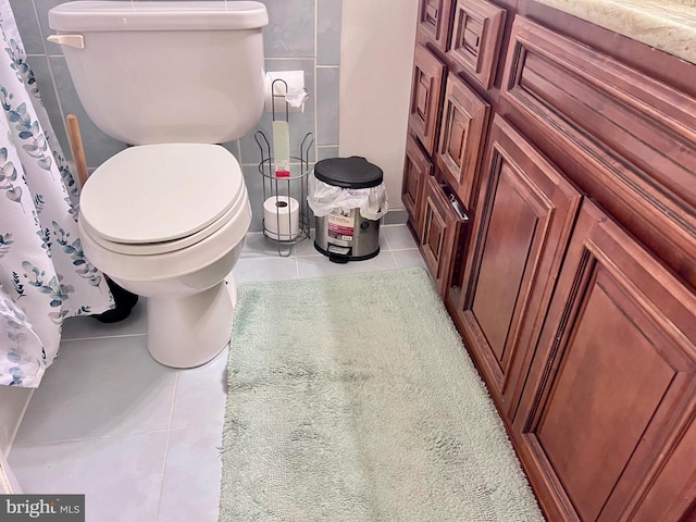 bathroom featuring walk in shower, toilet, and tile patterned flooring