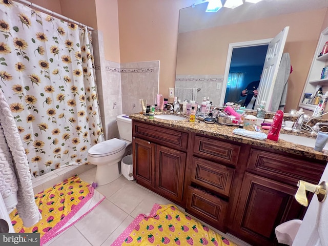 bathroom featuring tile walls, toilet, vanity, curtained shower, and tile patterned floors