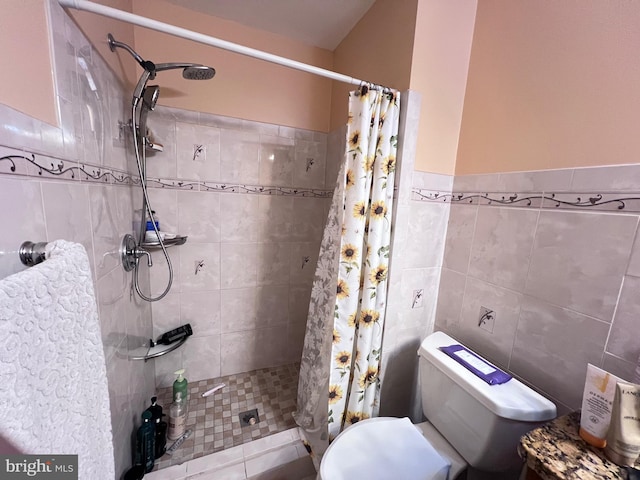 bathroom featuring toilet, curtained shower, and tile walls