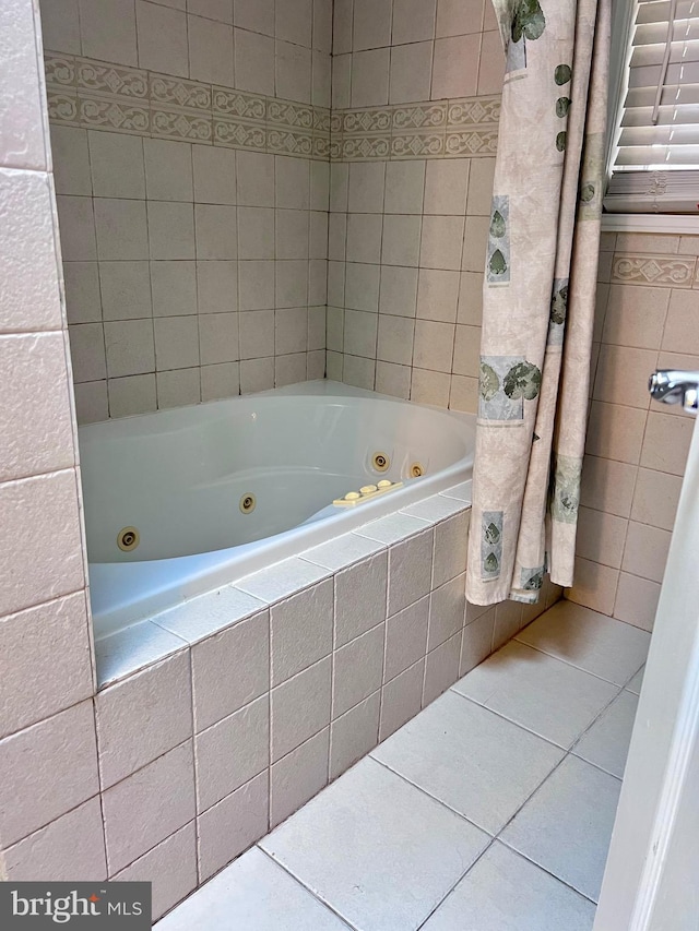 bathroom with tile patterned floors and tiled bath