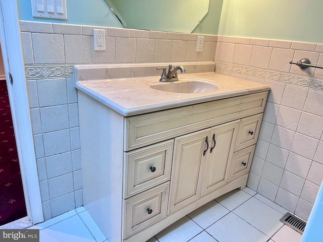 bathroom featuring vanity, tile walls, and tile patterned flooring