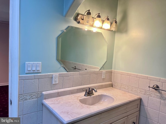 bathroom featuring vanity and tile walls