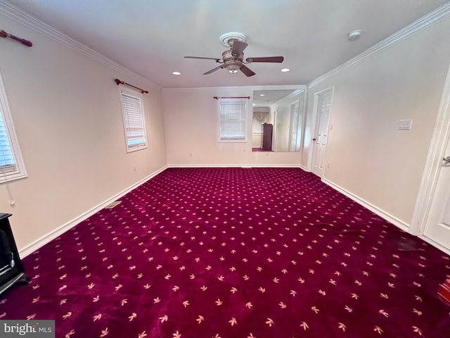 carpeted spare room featuring crown molding and ceiling fan