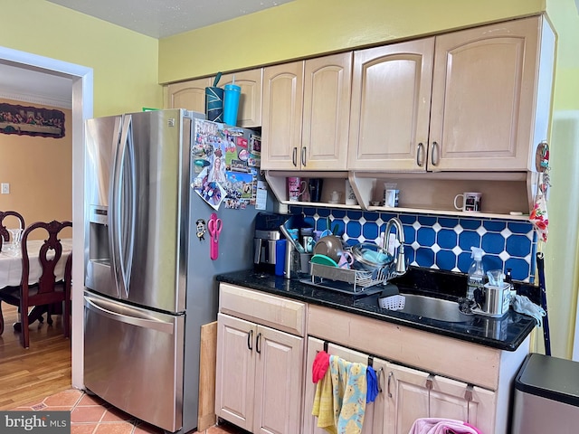 kitchen featuring light wood-type flooring and stainless steel fridge