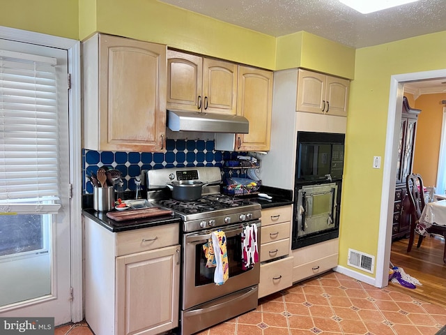 kitchen featuring light brown cabinets, tasteful backsplash, a textured ceiling, light hardwood / wood-style floors, and stainless steel range with gas cooktop