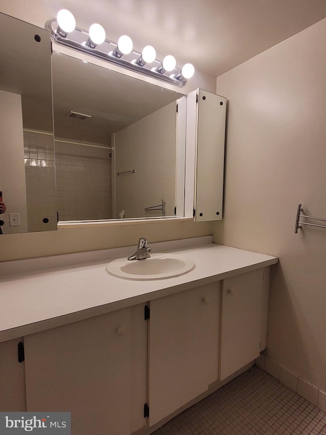 bathroom with tile patterned floors and vanity