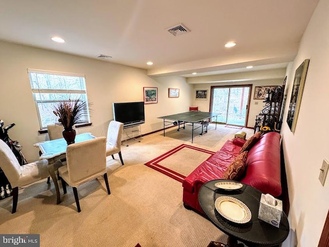 recreation room with light carpet and a wealth of natural light