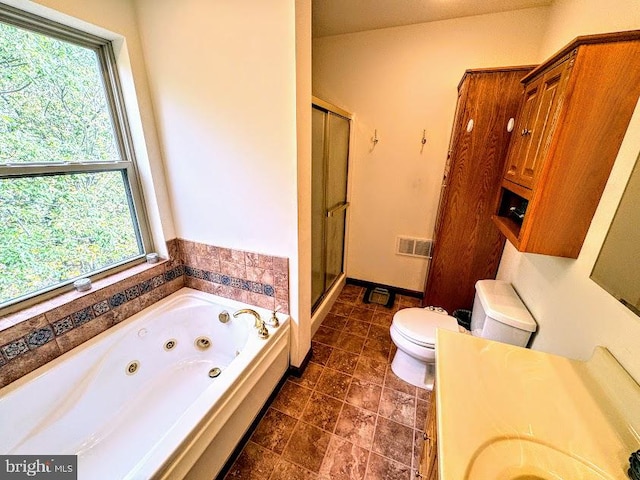 full bathroom with vanity, plenty of natural light, plus walk in shower, and toilet