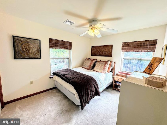 bedroom featuring carpet floors, multiple windows, and ceiling fan