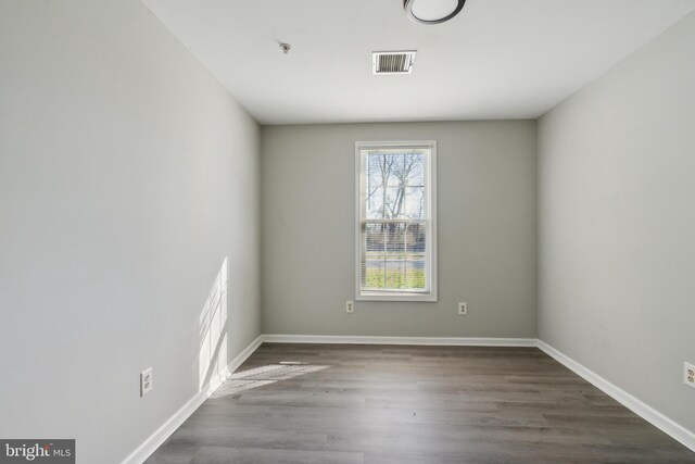 unfurnished room featuring dark wood-type flooring