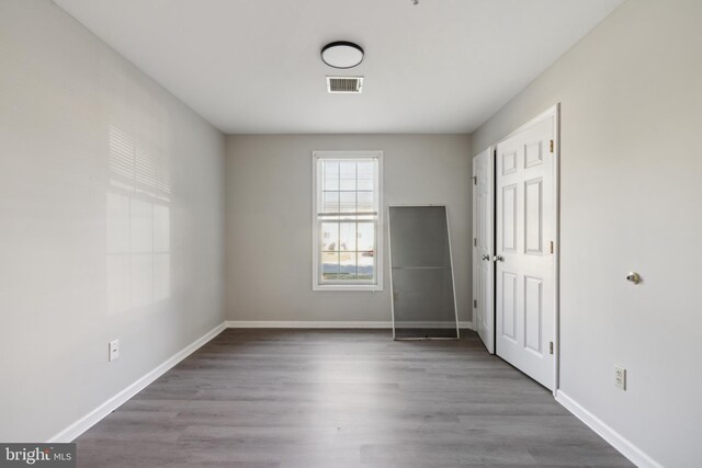 unfurnished bedroom featuring hardwood / wood-style flooring