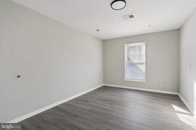 spare room with dark wood-type flooring