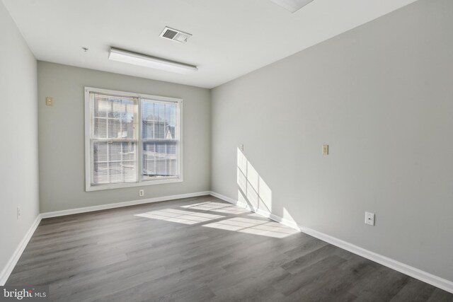 empty room with hardwood / wood-style floors