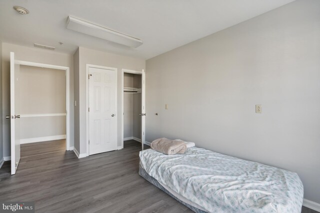 bedroom featuring a closet and dark hardwood / wood-style floors