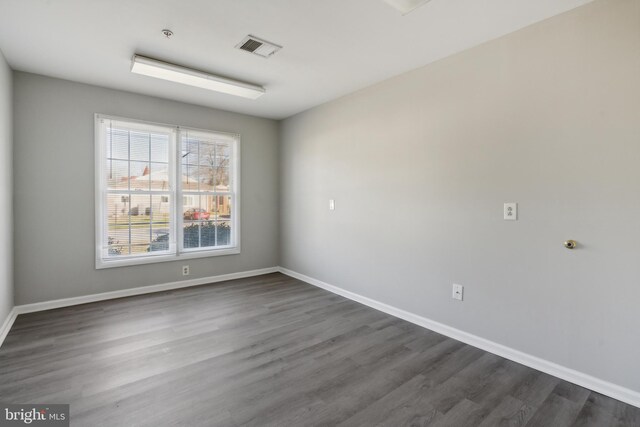 spare room with dark hardwood / wood-style flooring