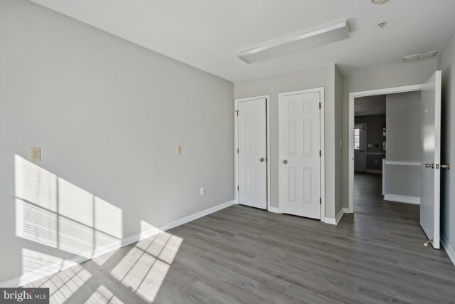 unfurnished room featuring dark hardwood / wood-style flooring