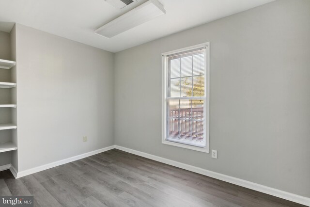 empty room with hardwood / wood-style floors