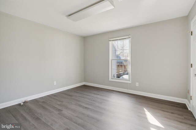 unfurnished room with hardwood / wood-style flooring