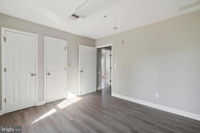 unfurnished bedroom featuring dark hardwood / wood-style floors