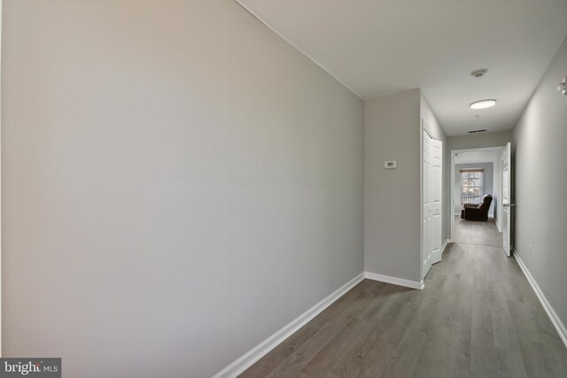 corridor with hardwood / wood-style floors