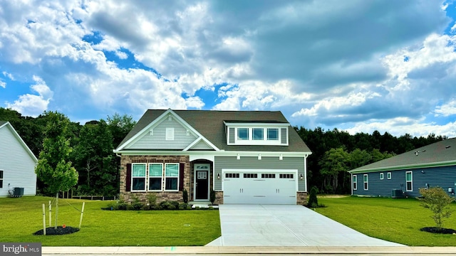 craftsman-style home featuring a garage, cooling unit, and a front yard