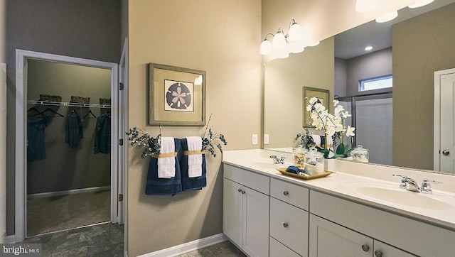 bathroom with vanity and a shower with shower door