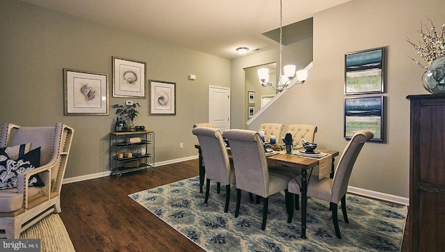 dining room featuring dark wood-type flooring and an inviting chandelier