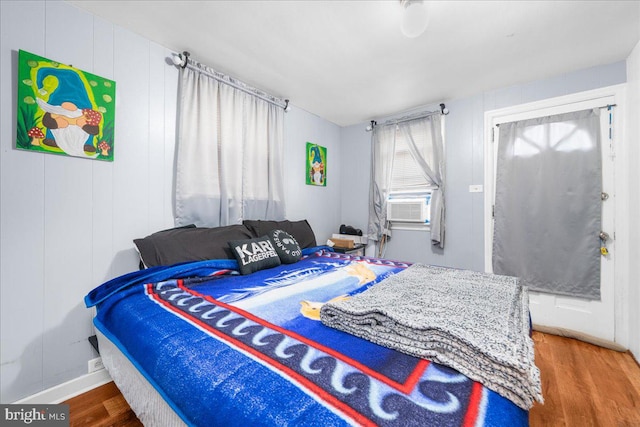 bedroom featuring cooling unit and hardwood / wood-style flooring