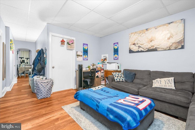 living room featuring a drop ceiling and hardwood / wood-style flooring